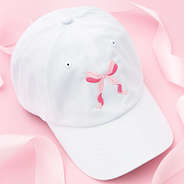 pink bow baseball cap on pink background