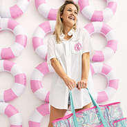 girl wearing white monogrammed fishing shirt with mesh tote