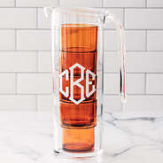 monogrammed acrylic pitcher with nesting cups in orange on kitchen counter