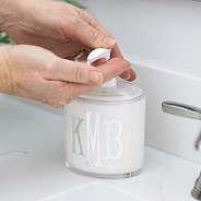 monogrammed clear soap dispenser being used