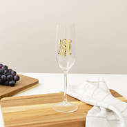 Personalized acrylic champagne glass empty on table