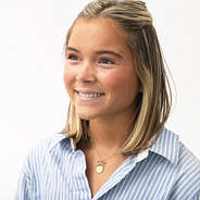 girl wearing gold bow necklace