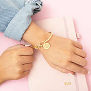 girl wearing gold bow bangle