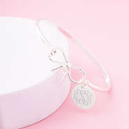 silver bow bangle on pink