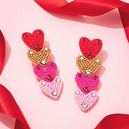 pink layered heart earrings with red ribbon
