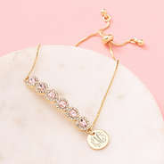 monogrammed rhinestone heart bracelet on marble dish