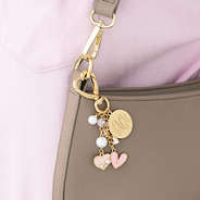 personalized gold bag charm keychain on shoulder bag