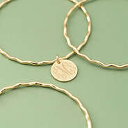 Gold Scalloped Bangle Set on green