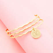 gold scalloped bangle set on pink