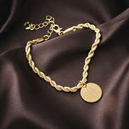 close up of gold monogrammed twisted rope bracelet