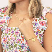 girl wearing monogrammed twisted rope bracelet and necklace in gold
