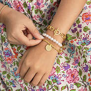 girl wearing personalized twisted rope bracelet in gold