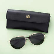 black sunglasses case on green background
