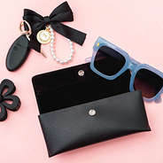 black sunglasses case on pink background