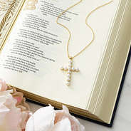 Pearl cross necklace on bible