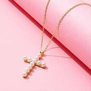 pearl cross necklace on pink