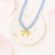 Beaded bow necklace on marble