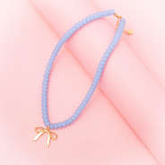 Beaded bow necklace on pink