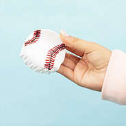 hand holding a baseball hair clip