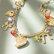 beaded charm necklace on green background