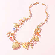 beaded charm necklace on pink background