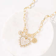 Charm heart necklace on marble dish