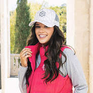 girl wearing camo trucker hat with vest