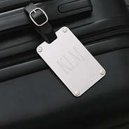 silver stainless steel luggage tag on luggage