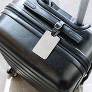 silver stainless steel luggage tag on suitcase
