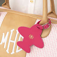 hot pink monogrammed luggage tag on pink seersucker weekender