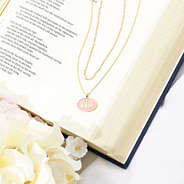 pink wwjd necklace on bible
