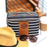 monogrammed train case with hat, sunglasses and coffee