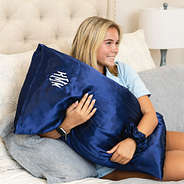 girl with navy satin pillowcase scrunchie on bed