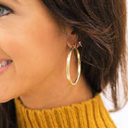 girl wearing gold lightweight hoop earrings