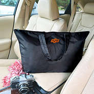 duffel bag on car center console with flowers