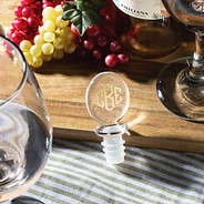 wine stopper on wooden table with grapes