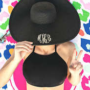 monogrammed black derby hat with multi leopard towel