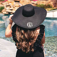black monogrammed derby hat at the pool