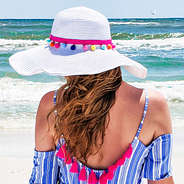 white beach hat with colorful poms with waves