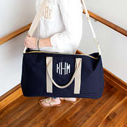 monogrammed essential travel bag on shoulder