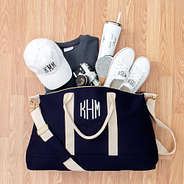 monogrammed travel bag with spilled contents