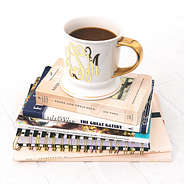 monogrammed coffee mug on stack of books