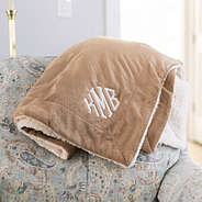 brown monogrammed sherpa blanket on chair