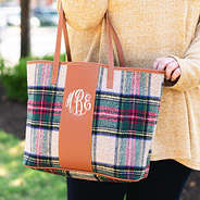 monogrammed plaid and leather tote bag on arm