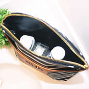 inside monogrammed shampoo bag with bottles