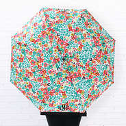 personalized umbrella in wild blooms on white brick