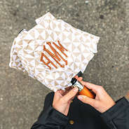 tan checker umbrella in hands