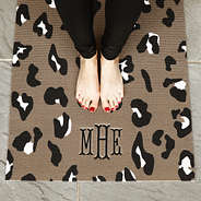 girl standing on monogrammed leopard yoga mat