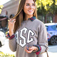 collared layering tunic under monogrammed letterman sweatshirt