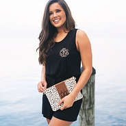 monogrammed romper with cinched waist and leopard print clutch